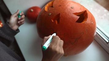 Close up on Hands and Knife Carving a Pumpkin video
