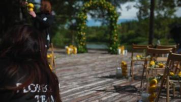 Woman decorates an arch with real branches and lemons for an event video