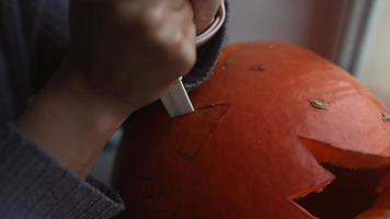 Close up on Hands and Knife Carving a Pumpkin video