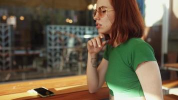 Two women talk and hang out at sunny coffee shop video