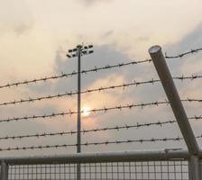 barbed wire steel wall against the immigations. photo