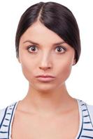 Outraged and evil. Angry young women staring at camera while standing against white background photo