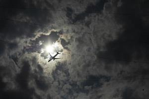 Airplane among clouds. Air transport in sky. Flight details. photo