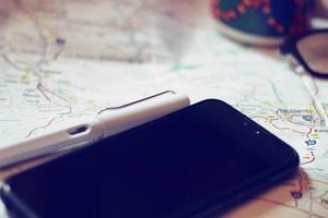 Map, map of Washington state, pen, glasses, cell phone, coffee cup on the table. photo