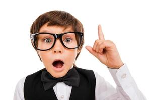 He has got an idea. Surprised young boy in bow tie and gesturing while isolated on white photo