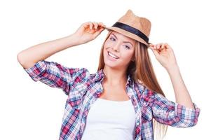 I love my style. Happy young women holding hands on hat while standing against white background photo