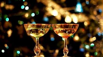 two drinking glasses. against the backdrop of the city lights. new year campaign video