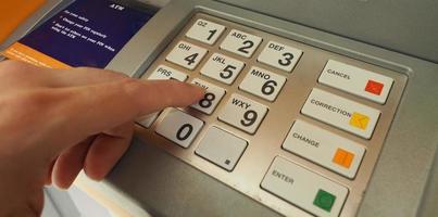 ATM machine and close-up man hand. photo