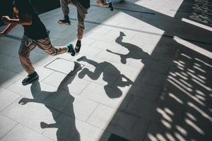 Low angle view of a boy shadows running along a corridor photo