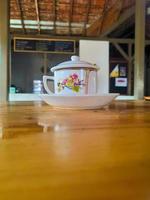 Cup of coffee on table in coffee shop photo