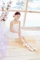 Young ballerina girl is preparing for a ballet performance. Little prima ballet photo