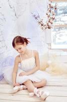 Little prima ballet. Young ballerina girl is preparing for a ballet performance photo