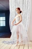 Little prima ballet. Young ballerina girl is preparing for a ballet performance photo