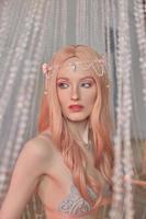 Beauty portrait of anime princess elf woman with pink hair in underwear. Fabulous magical look, beautiful pink makeup. Rim crown on the head of a woman photo