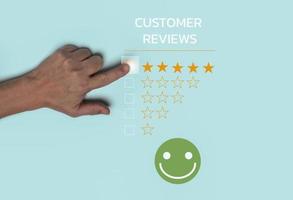 Customer review satisfaction concept, Hand choosing Five stars ratting with Positive emotion smiley face icon. photo