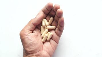 Overhead view of a hand holding large pill capsules in palm video