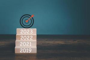 2023 New Year goals setting on wooden box and Target Logo with copy space on the table. photo