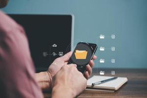 Man using mobile smartphone. Document management system, DMS, online documentation database and process automation to efficiently manage files. photo