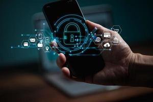 Cybersecurity and privacy concepts to protect data. Lock icon and internet network security technology. Businessman protecting personal data on smart phone with virtual screen interfaces. photo