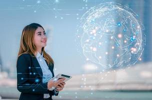 Future Global Communication Network Technology concept, Business woman holding tablet happy, enjoy, satisfaction to communicate with internet network information and other people together. photo