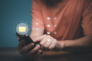 Man using mobile smartphone. Document management system, DMS, online documentation database and process automation to efficiently manage files. photo