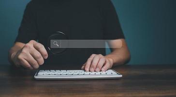 Magnifying glass keyboard computer and search bar or search box on virtual screen, browsing Internet global data Information. photo