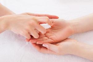 Applying antiseptic. Close-up of manicure master spraying antiseptic on female palm photo