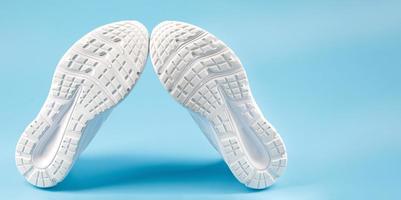 The white sole of sports sneakers. A couple of white sneakers. photo