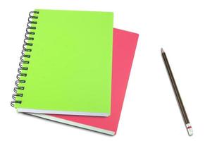 colored notebook and pencils isolated on white background photo