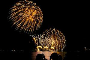 fireworks celebration over sea in pattaya beach photo