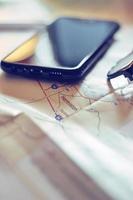 Map, map of Washington state, pen, glasses, cell phone, coffee cup on the table. photo