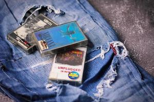 WASHINGTON USA - September 30 2022  Nirvana's cassette tape and Ripped jeans or Torn jeans. A symbol of the grunge or Seattle sound. photo