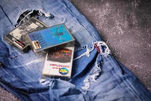 WASHINGTON USA - September 30 2022  Nirvana's cassette tape and Ripped jeans or Torn jeans. A symbol of the grunge or Seattle sound. photo