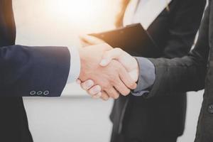 Two confident businessman shook hands during office meetings. photo