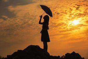 Silhouette sad girl at sunset. photo