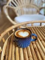 Heart latte art on coffee cup photo