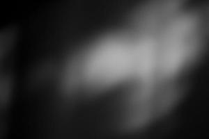Dark black and gray blurred gradient and leaf shadow background has a little abstract light. photo