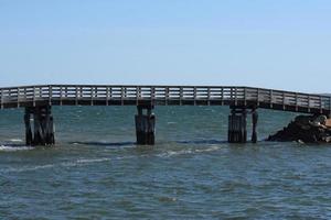 Wood Bridge Over the Ocean Waters in Plymouth photo