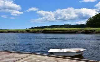 Row Boat Just Off a Dock in a River photo