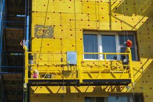 Insulation of the walls of a multi-storey building, The cradle of the lift. photo