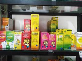 Depok, Indonesia, October 21, 2022, various brands of liquid medicine or syrup to reduce fever, relieve dry cough and phlegm for children or adults found in drug stores or pharmacies photo