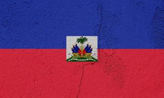 Flag of the Republic of Haiti On the texture of a cement cracked wall. photo