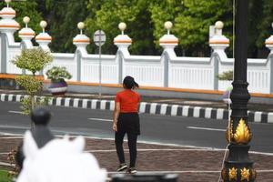 Magelang, Indonesia, 2022 - photo of a woman walking on the sidewalk in the evening