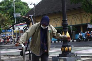 Magelang, Indonesia, 2022 - photo of an old woman walking on the sidewalk in the afternoon