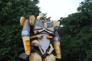 Magelang, Indonesia, 2022 - photo of a large yellow robot statue on the edge of the park