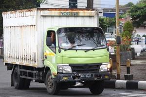 Magelang, Indonesia, 2022 - Photo of a colorful cargo truck driving down the street in the evening