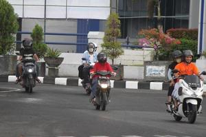 Magelang, Indonesia, 2022 - photo of many motorized vehicles driving on the streets in the afternoon