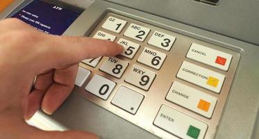 ATM machine and close-up man hand. photo