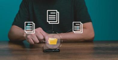 Man using mobile smartphone. Document management system, DMS, online documentation database and process automation to efficiently manage files. photo