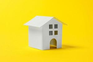 Simply design with miniature white toy house isolated on yellow colourful trendy modern fashion background. Mortgage property insurance dream home concept. Copy space. photo